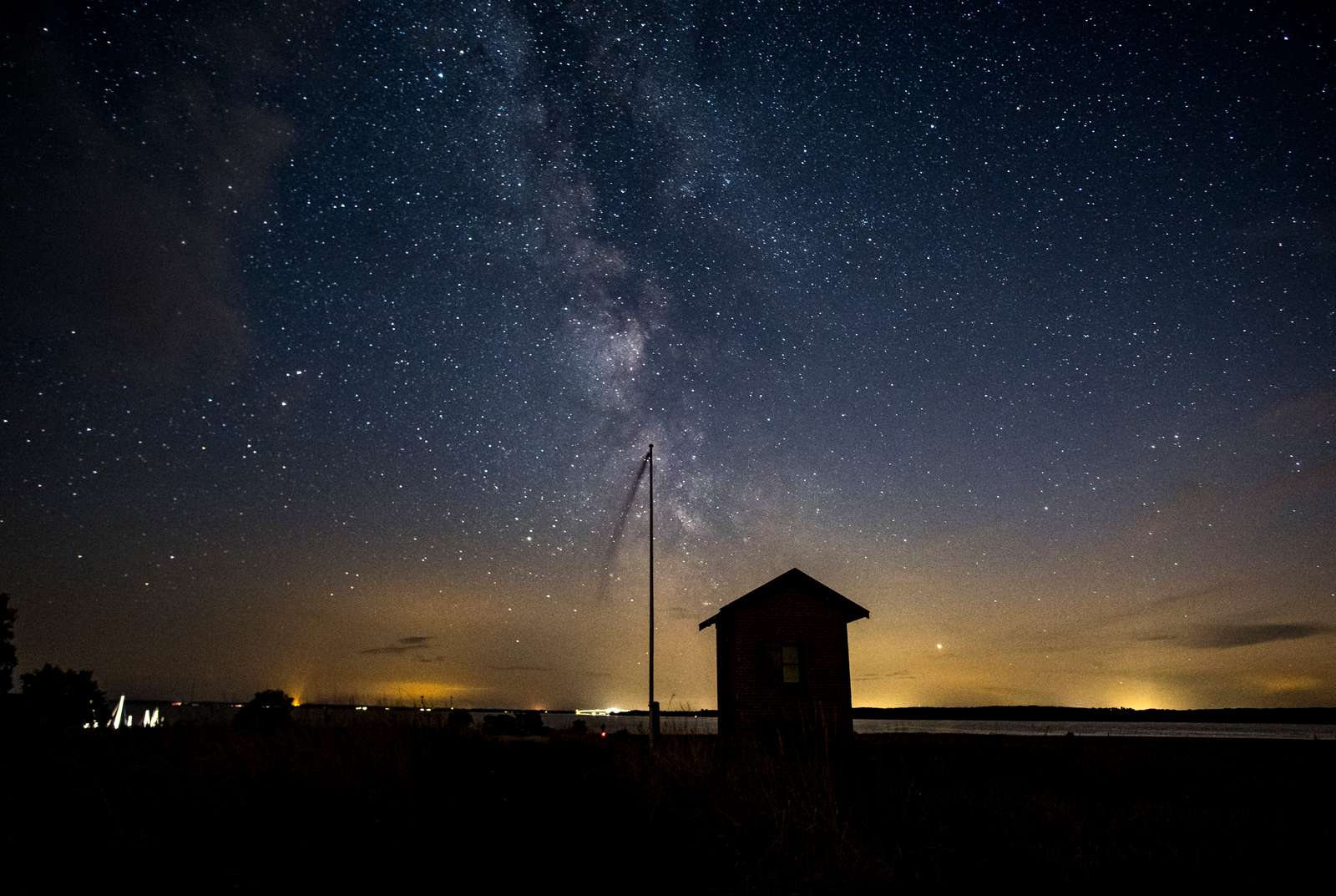 Starry sky with the Milky Way above the landscape of Møn